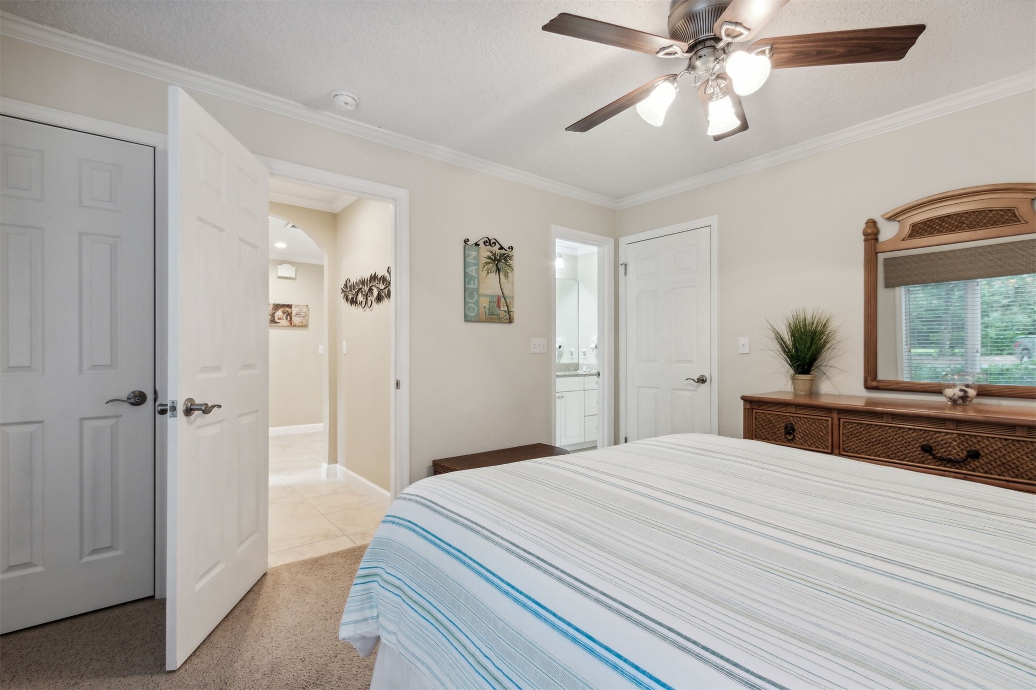3327 Sea Marsh Road, Unit 3327 Fernandina Beach, FL 32034 - Photo 21 of 39 a bedroom with a bed and a chandelier