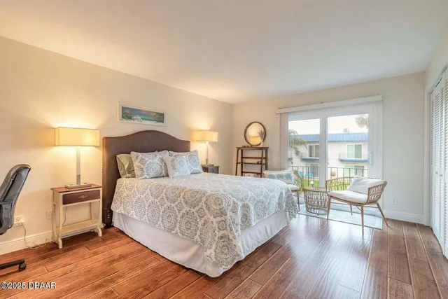 a bedroom with a large bed and a large window