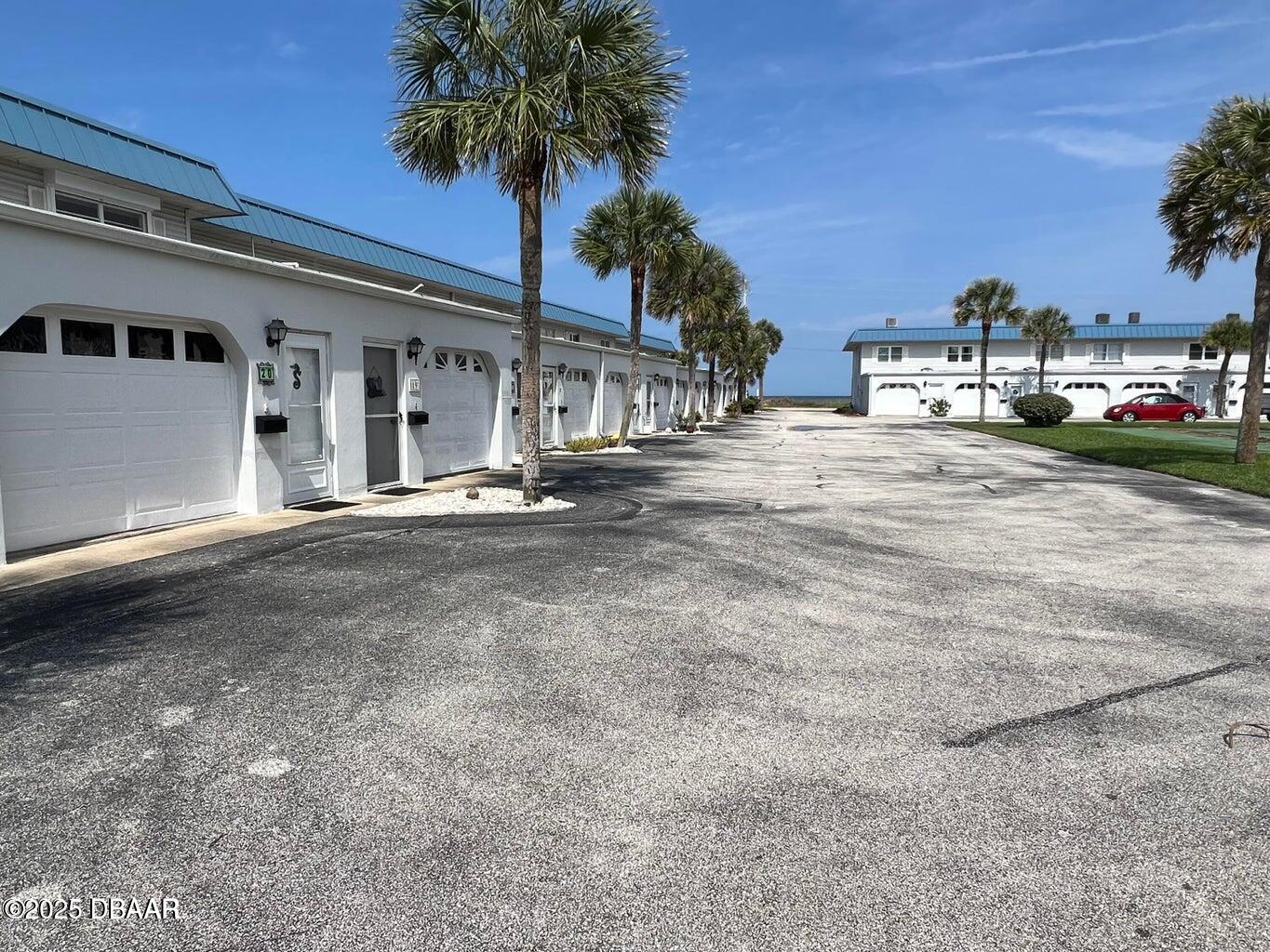 2750 Ocean Shore Boulevard, Unit 19 Ormond Beach, FL 32176 - Photo 19 of 23 a front view of a house with a yard and garage