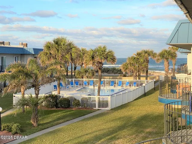a view of a swimming pool with an outdoor seating