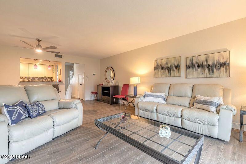 2750 Ocean Shore Boulevard, Unit 19 Ormond Beach, FL 32176 - Photo 4 of 23 a living room with furniture and kitchen view