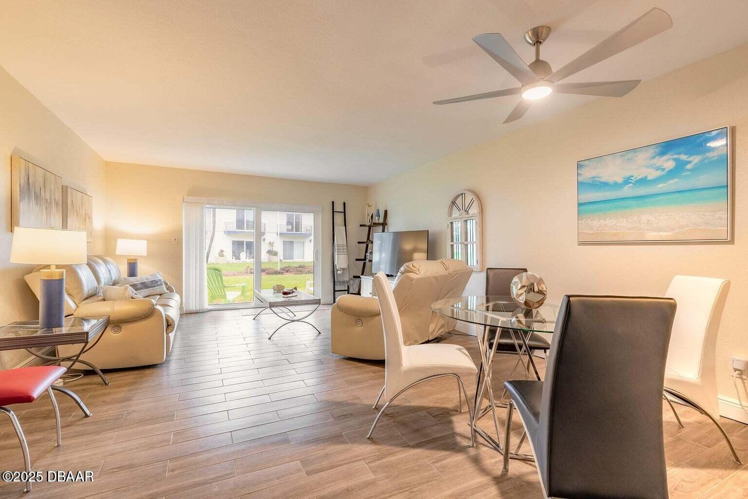2750 Ocean Shore Boulevard, Unit 19 Ormond Beach, FL 32176 - Photo 5 of 23 a living room with furniture and a large window