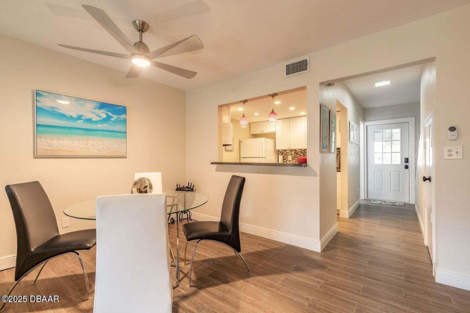 2750 Ocean Shore Boulevard, Unit 19 Ormond Beach, FL 32176 - Photo 6 of 23 a view of a dining room with furniture and wooden floor