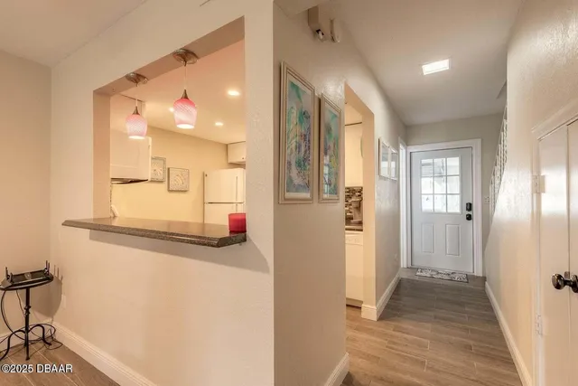 a view of a hallway with wooden floor