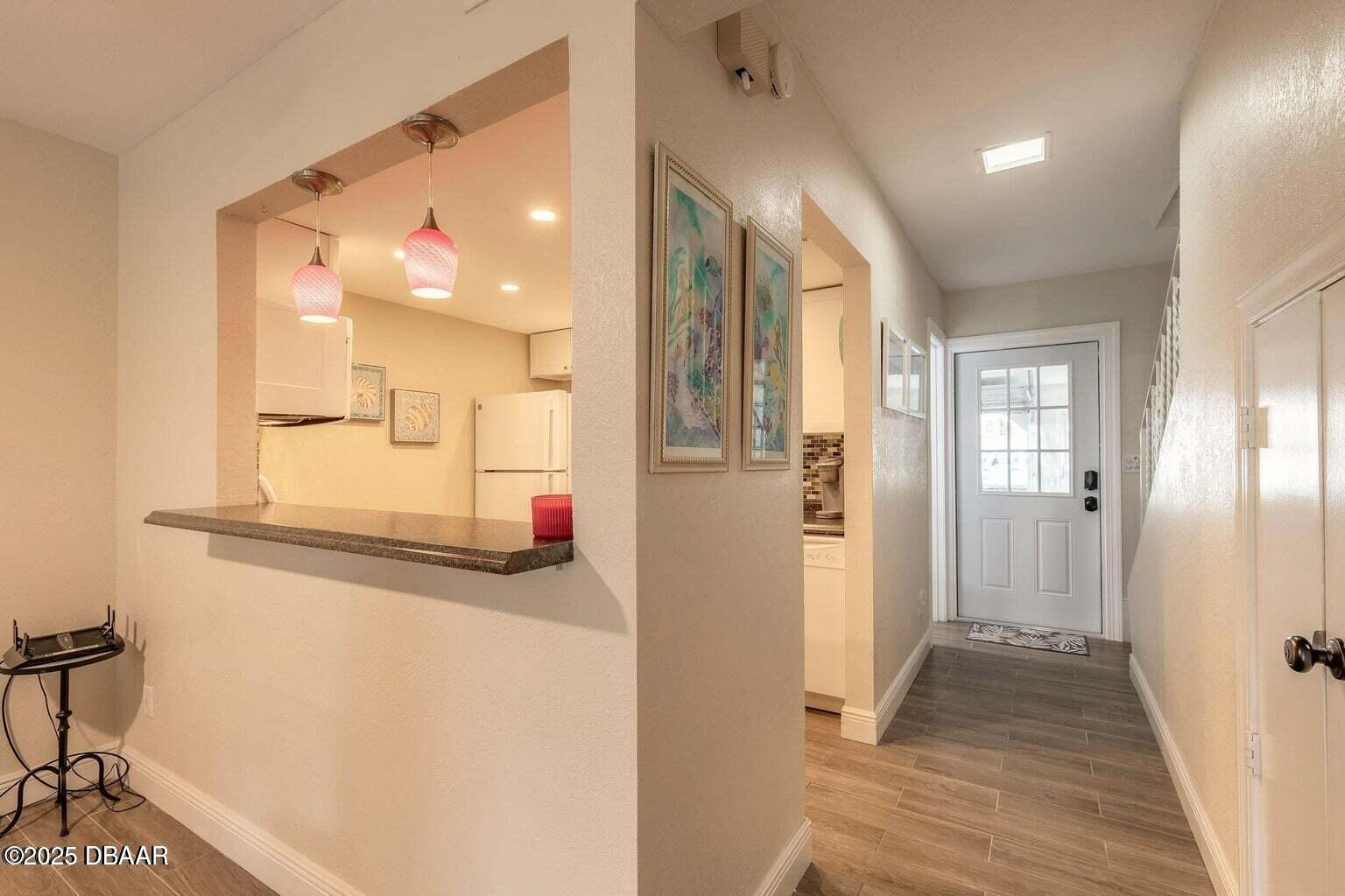 2750 Ocean Shore Boulevard, Unit 19 Ormond Beach, FL 32176 - Photo 7 of 23 a view of a hallway with wooden floor