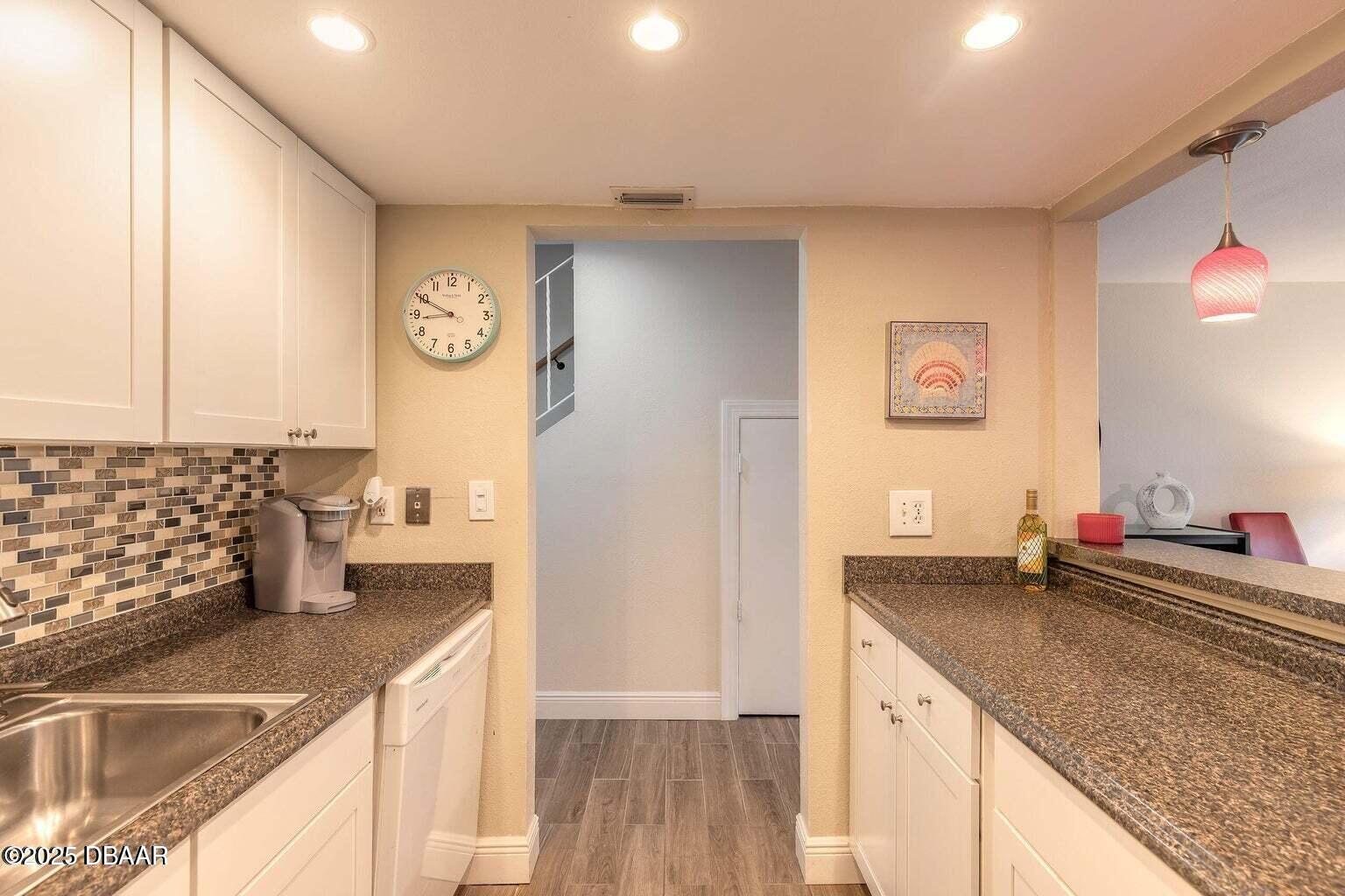 2750 Ocean Shore Boulevard, Unit 19 Ormond Beach, FL 32176 - Photo 9 of 23 a kitchen with stainless steel appliances granite countertop a sink and a refrigerator