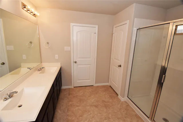a bathroom with a sink a mirror and a shower
