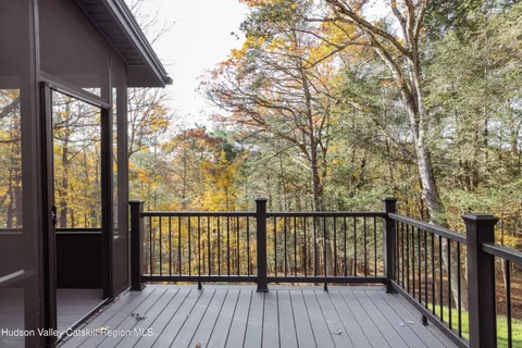 a view of balcony with wooden floor and fence