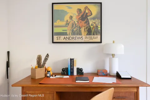 a kitchen with a sink and a painting on the wall