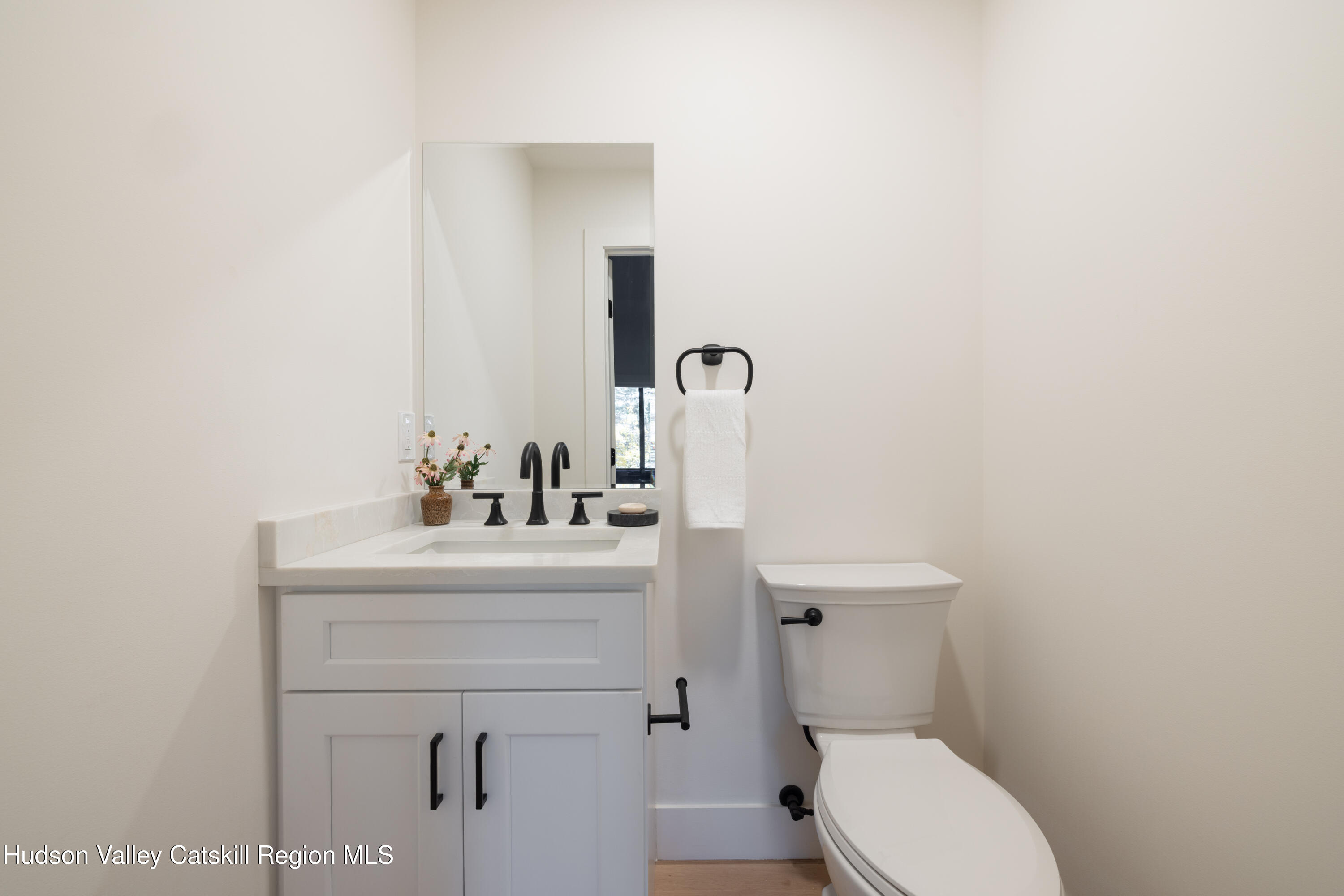 8 Watch Hill Road New Paltz, NY 12561 - Photo 18 of 30 a bathroom with a sink a toilet and mirror