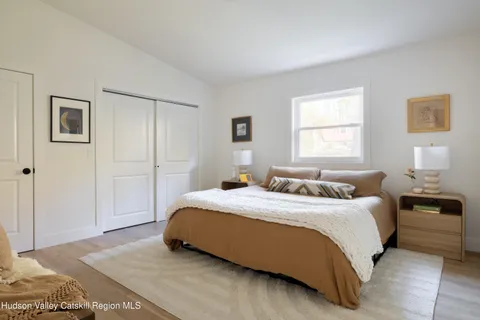 a bedroom with a bed and a lamp