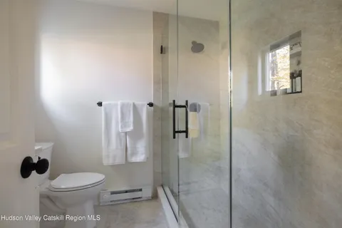 a bathroom with a toilet and a shower