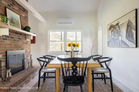 a view of a dining room with furniture and window