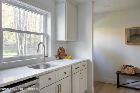 a kitchen with a sink cabinets and window