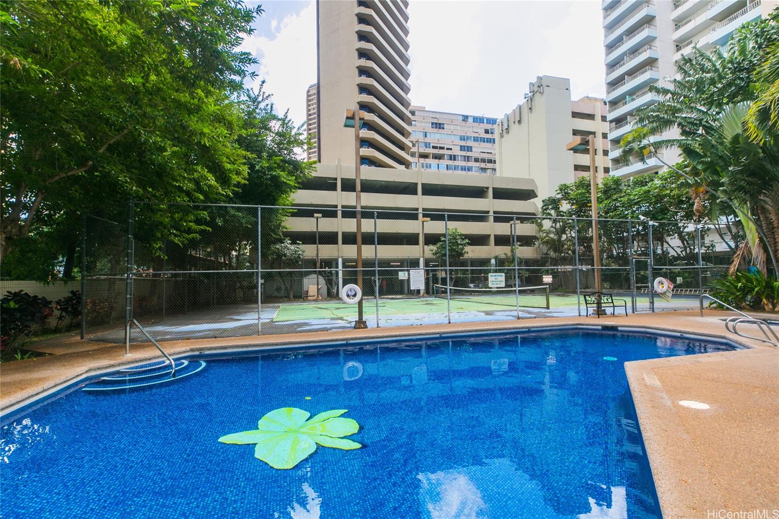 1700 Ala Moana Boulevard, Unit 603 Honolulu, HI 96815 - Photo 3 of 10 a view of a swimming pool with a bench and tables in the patio