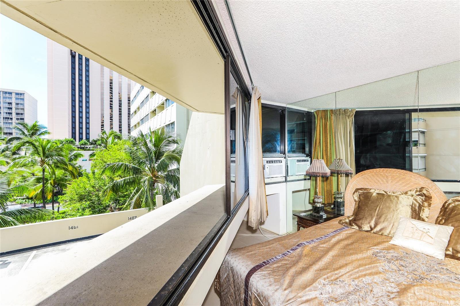 1700 Ala Moana Boulevard, Unit 603 Honolulu, HI 96815 - Photo 4 of 10 a bedroom with a bed and large window with balcony view