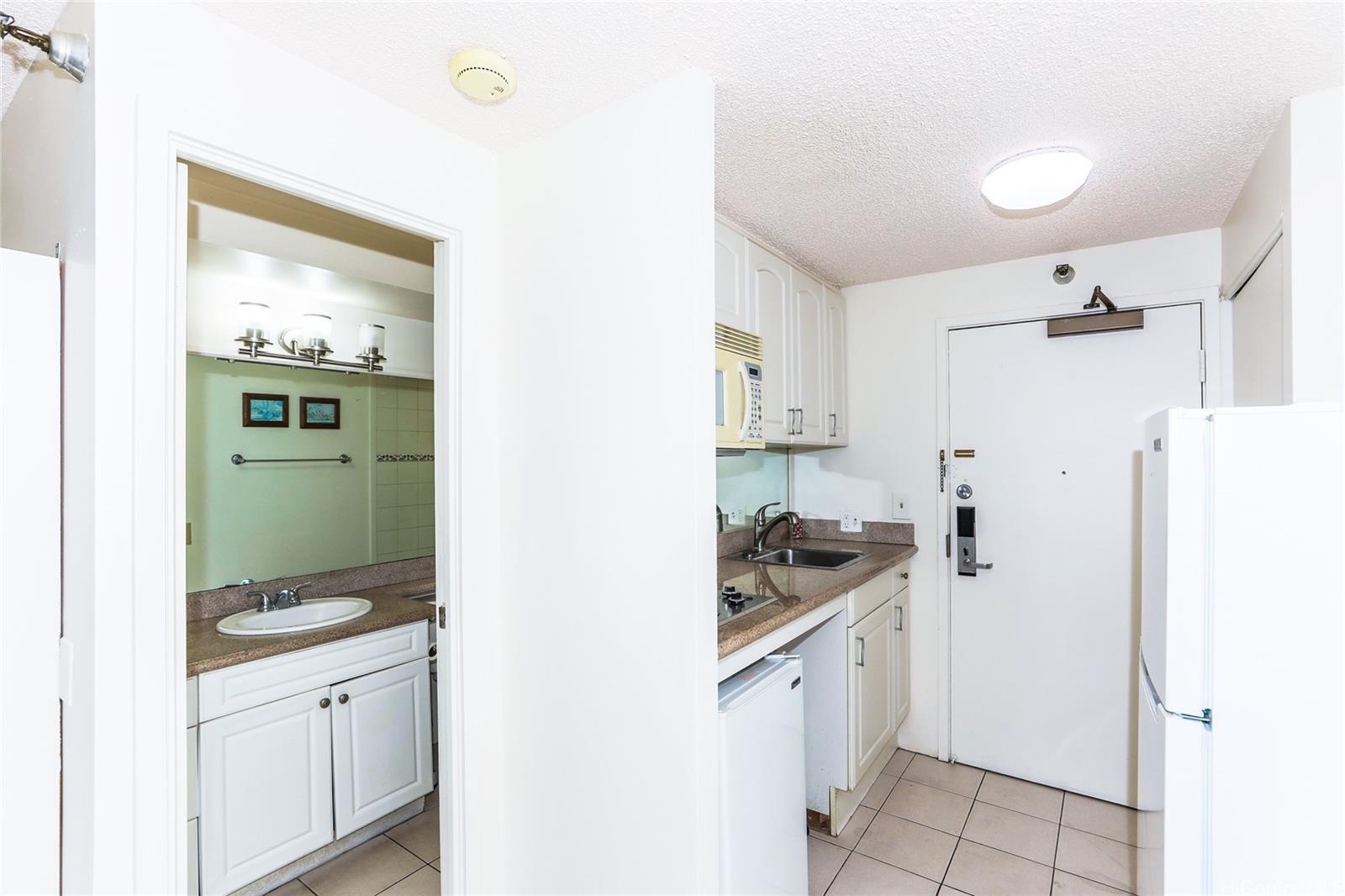 1700 Ala Moana Boulevard, Unit 603 Honolulu, HI 96815 - Photo 7 of 10 a kitchen with a refrigerator and a stove