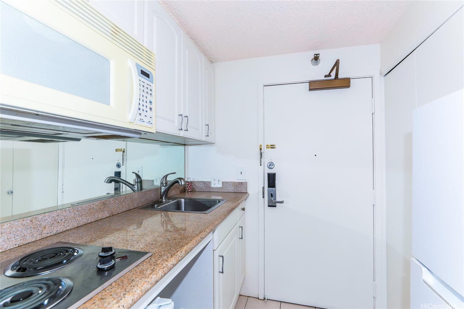 1700 Ala Moana Boulevard, Unit 603 Honolulu, HI 96815 - Photo 8 of 10 a kitchen with a sink and cabinets