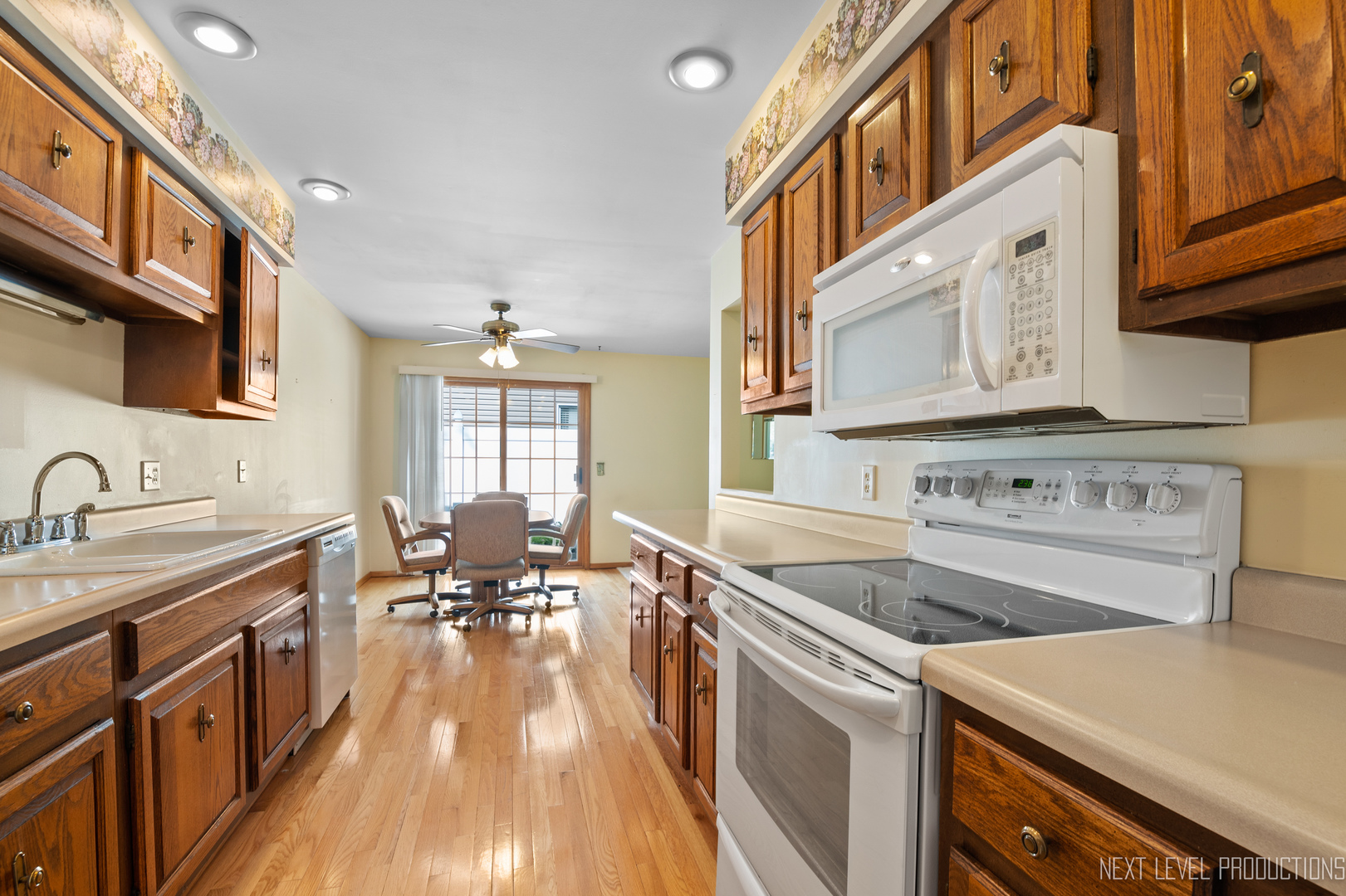 38 Sherwick Road Oswego, IL 60543 - Photo 15 of 25 a kitchen with a stove a sink and a refrigerator