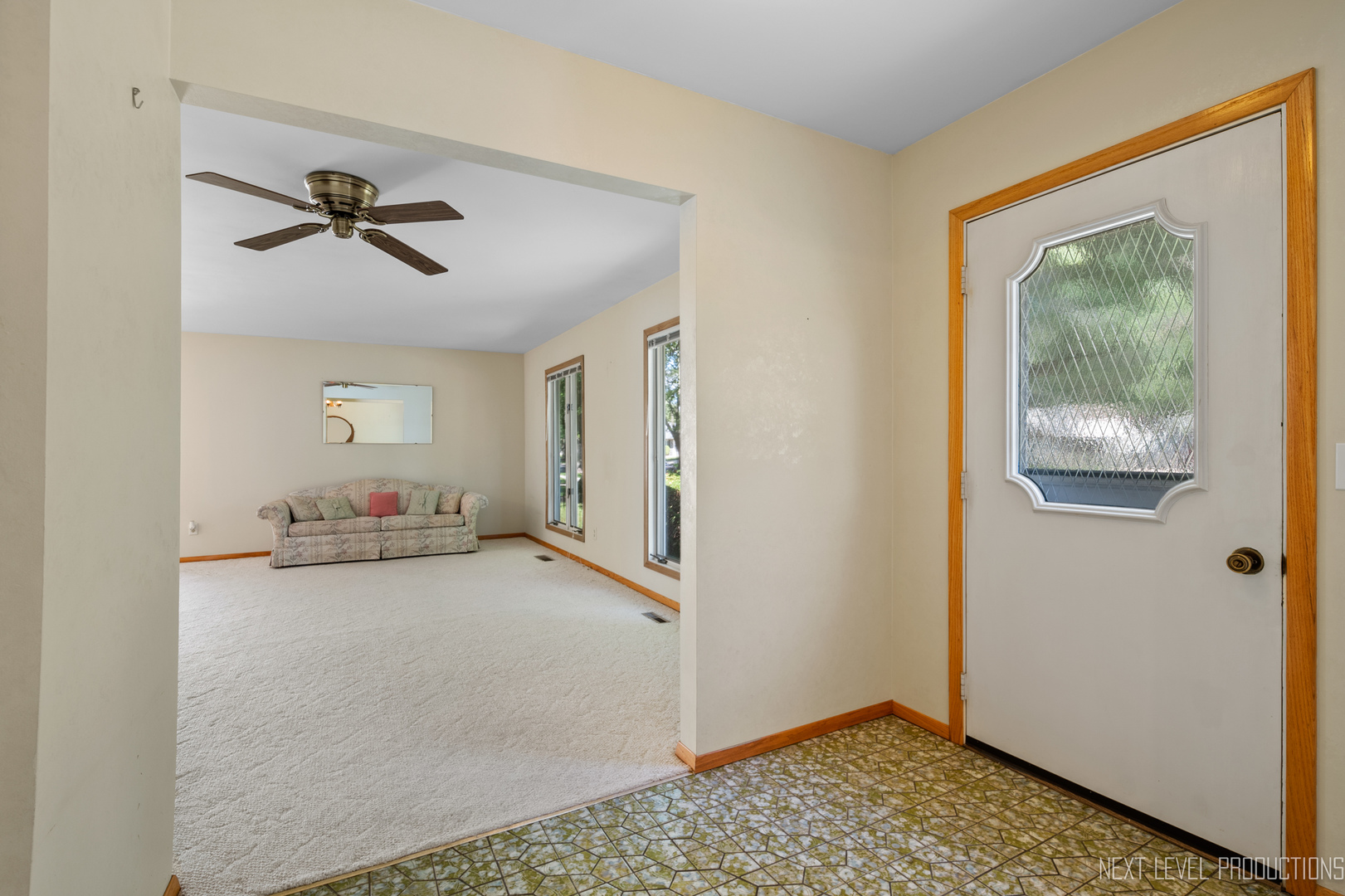 38 Sherwick Road Oswego, IL 60543 - Photo 5 of 25 a view of a livingroom with a chandelier fan and wooden floor