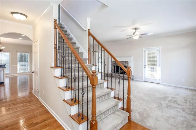 a view of an empty room with a fireplace and a window