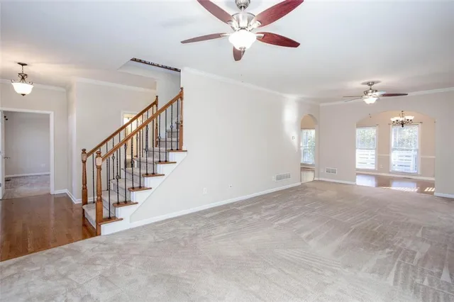 a kitchen with stainless steel appliances granite countertop a stove top oven a sink and white cabinets