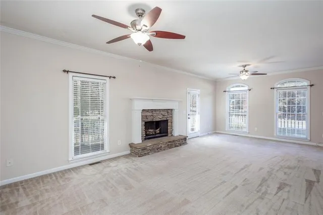 a kitchen with granite countertop white cabinets and stainless steel appliances