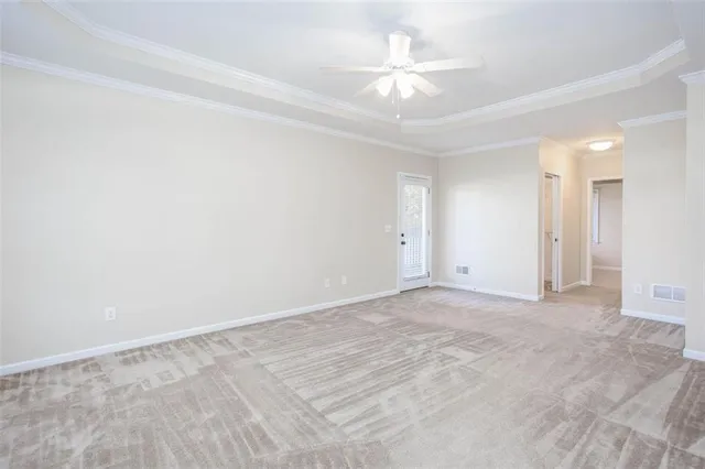 an empty room with a ceiling fan and a window