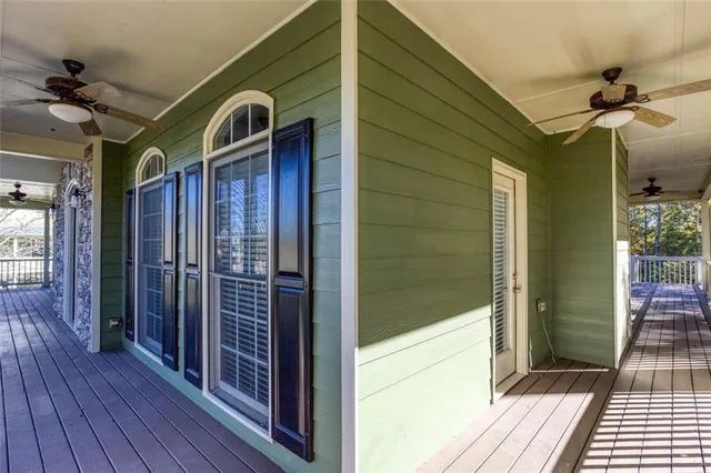 a view of balcony with wooden floor and fence