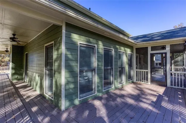 a view of outdoor space with wooden floor and a ceiling fan