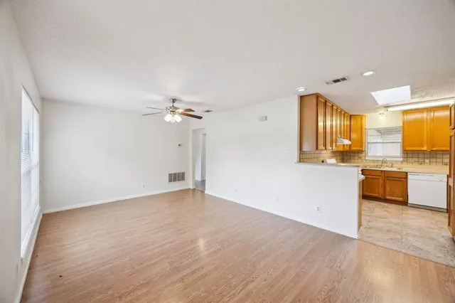 a view of a kitchen with a sink and a kitchen counter top space
