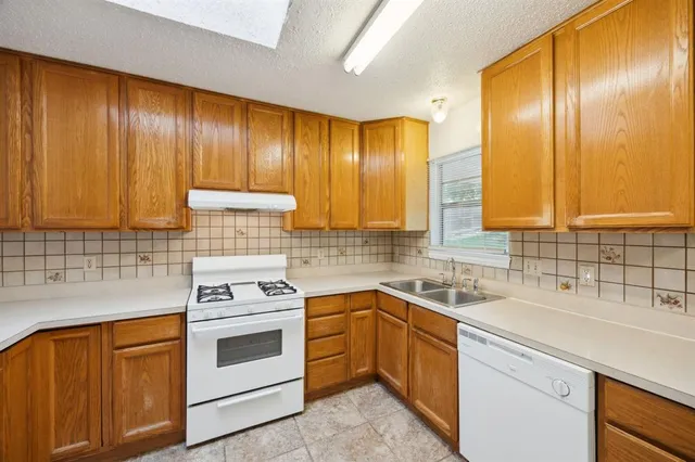 a kitchen with a sink stove and cabinets