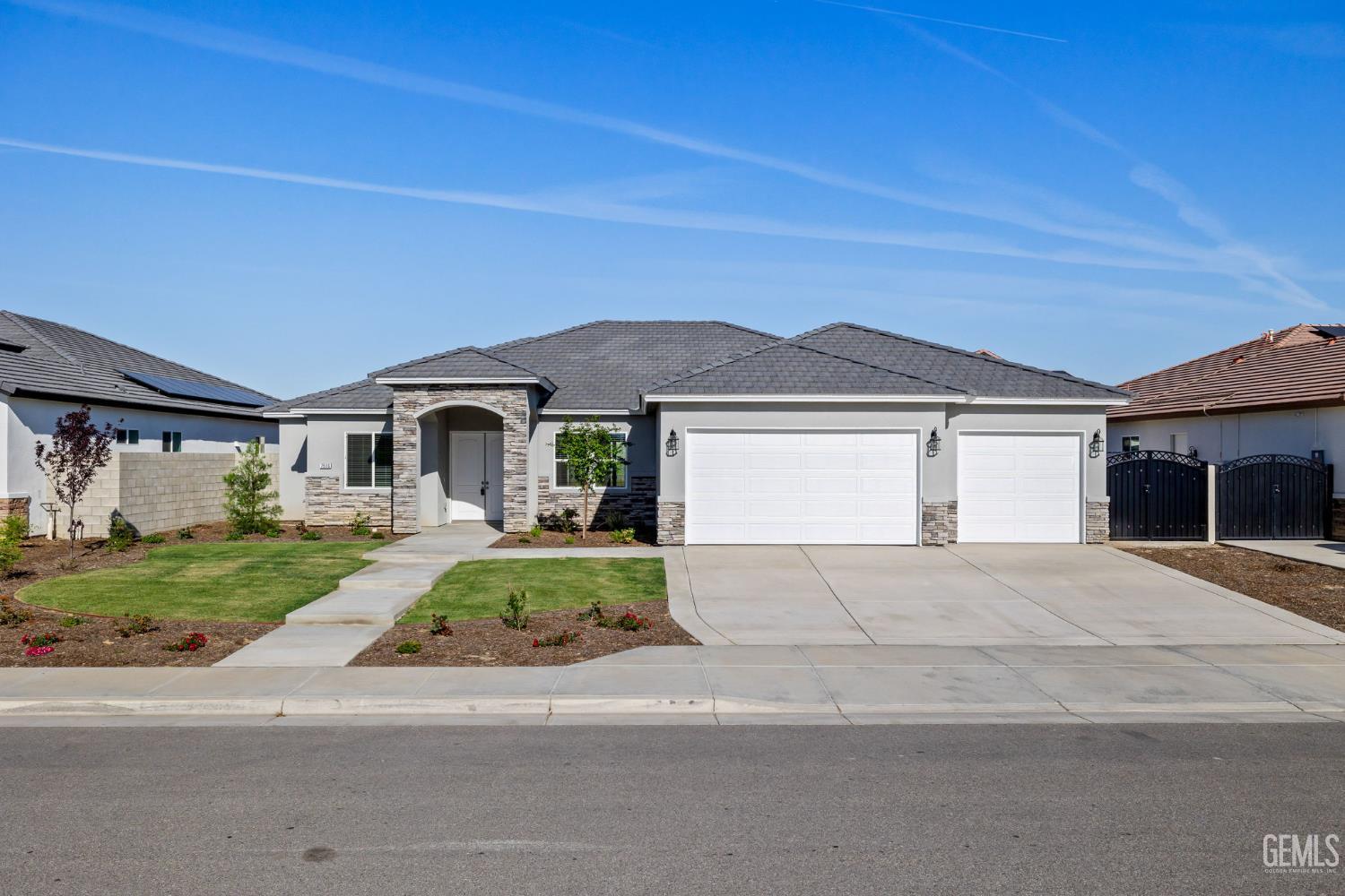 Undisclosed Address Bakersfield, CA 93314 - Photo 1 of 55 a front view of a house with a garden and yard