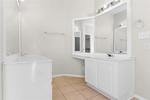 a bathroom with a sink a mirror and a vanity