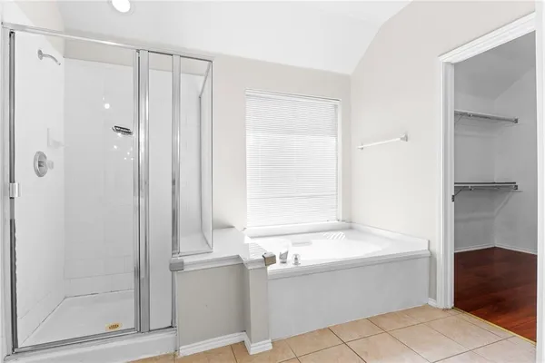 a bathroom with a bathtub and a shower