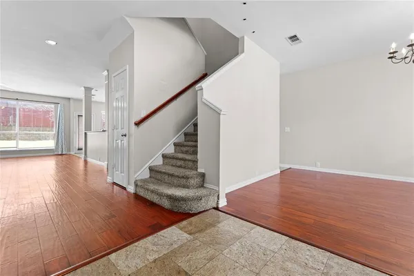 a view of entryway and hall with wooden floor