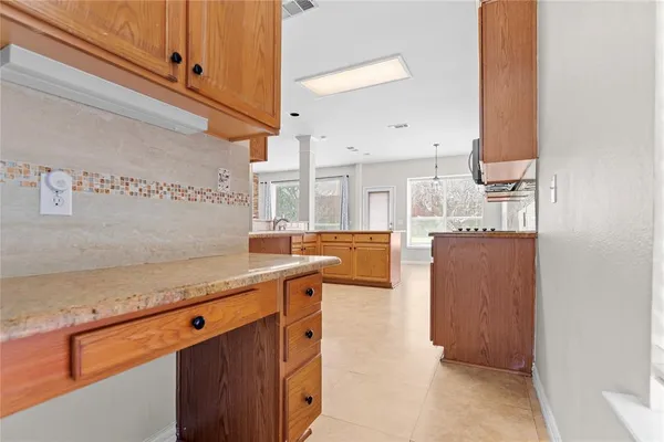 a kitchen with granite countertop a sink and cabinets