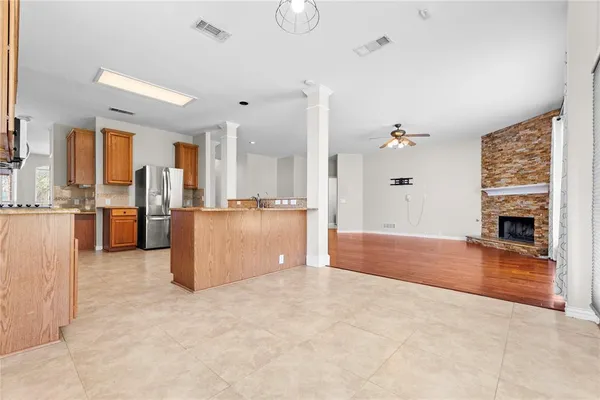 a view of kitchen with furniture and refrigerator
