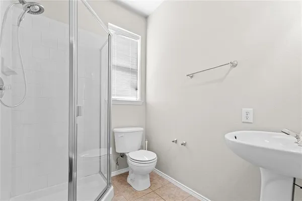 a white toilet sitting next to a bathroom sink