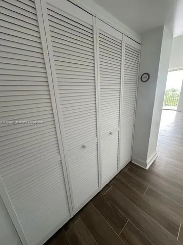 a view of a room with wooden floor