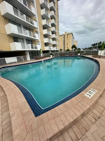 a view of a swimming pool with a yard