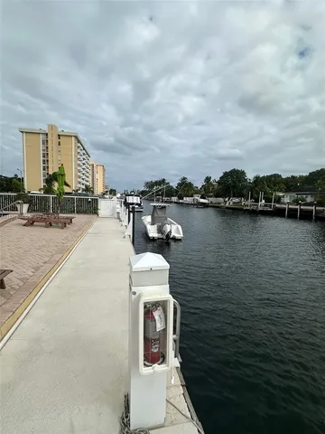 a view of a terrace with outdoor seating and lake view