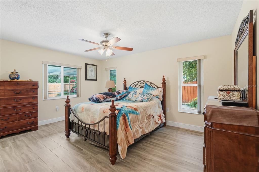 2370 Robyn Court Dunedin, FL 34698 - Photo 12 of 29 a bedroom with a bed and a chandelier
