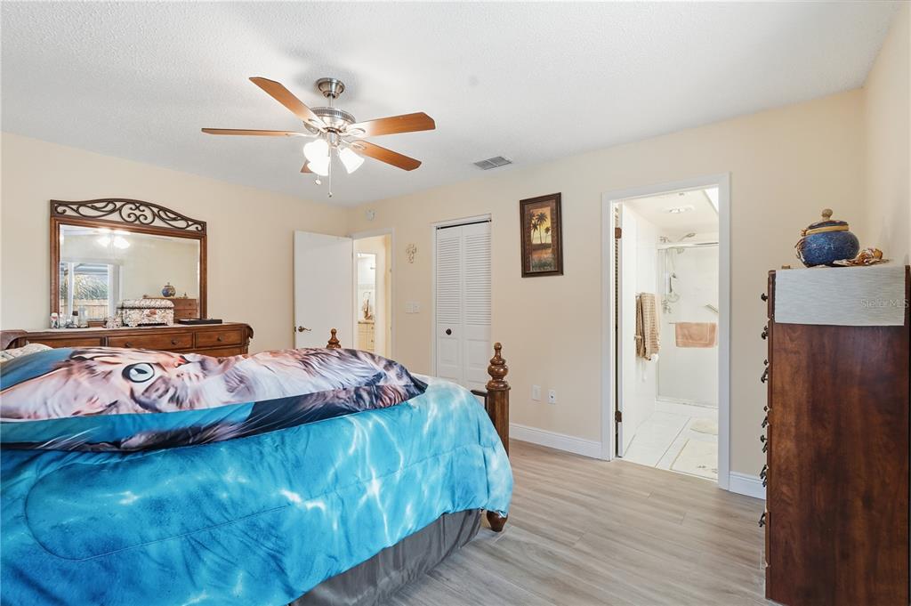 2370 Robyn Court Dunedin, FL 34698 - Photo 13 of 29 a bed room with a bed mirror and a window