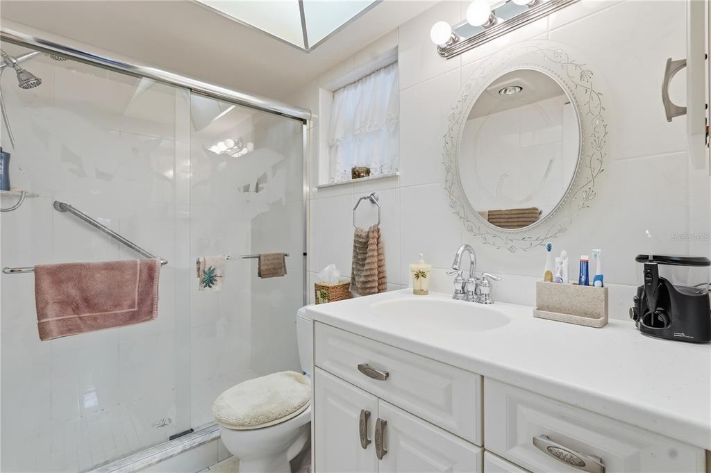 2370 Robyn Court Dunedin, FL 34698 - Photo 14 of 29 a bathroom with a sink a toilet and a mirror