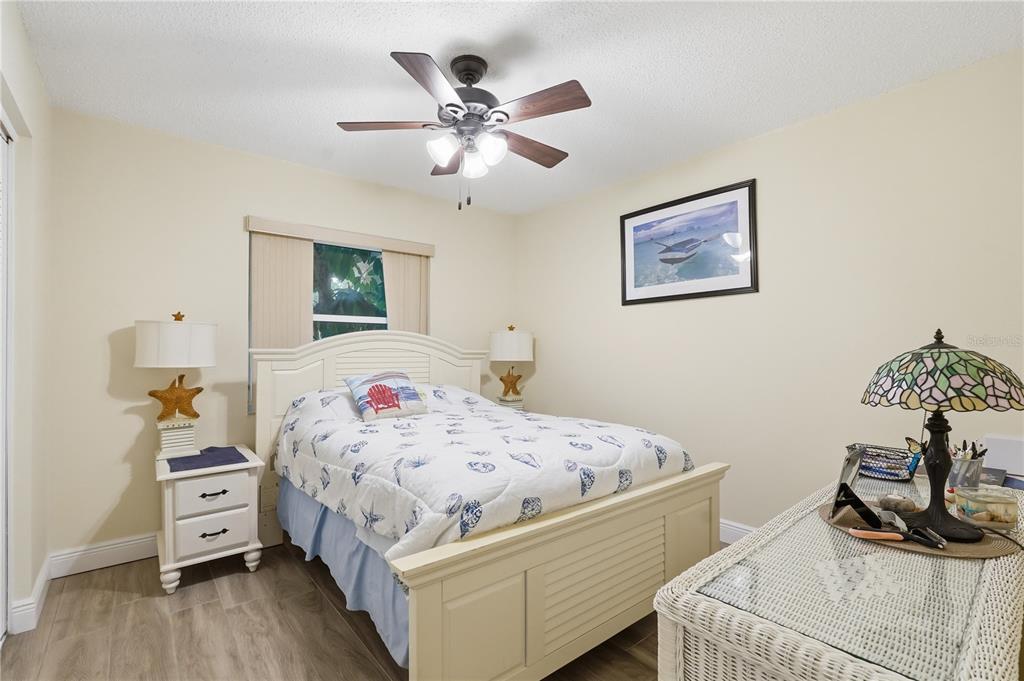 2370 Robyn Court Dunedin, FL 34698 - Photo 15 of 29 a bedroom with a bed and wooden floor