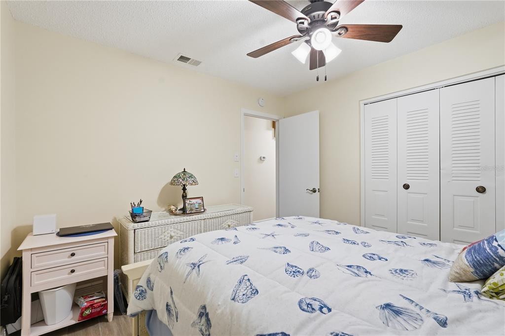 2370 Robyn Court Dunedin, FL 34698 - Photo 16 of 29 a bedroom with a bed and a dresser