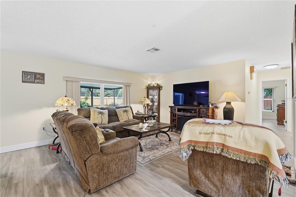 2370 Robyn Court Dunedin, FL 34698 - Photo 5 of 29 a living room with furniture and a flat screen tv