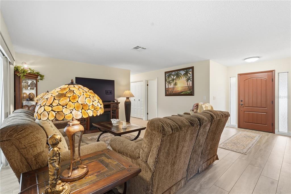 2370 Robyn Court Dunedin, FL 34698 - Photo 6 of 29 a living room with furniture and flowers