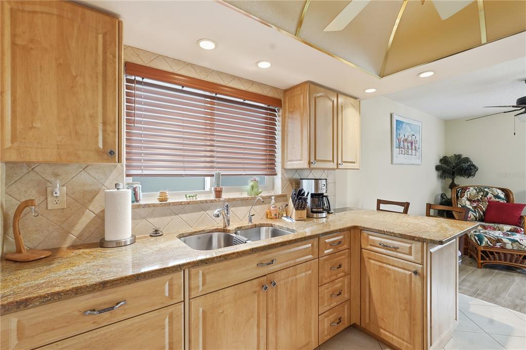 2370 Robyn Court Dunedin, FL 34698 - Photo 10 of 29 a kitchen with a sink stove and cabinets